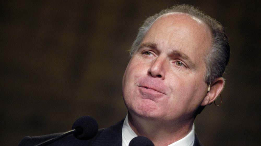 Rush Limbaugh grimacing into mics