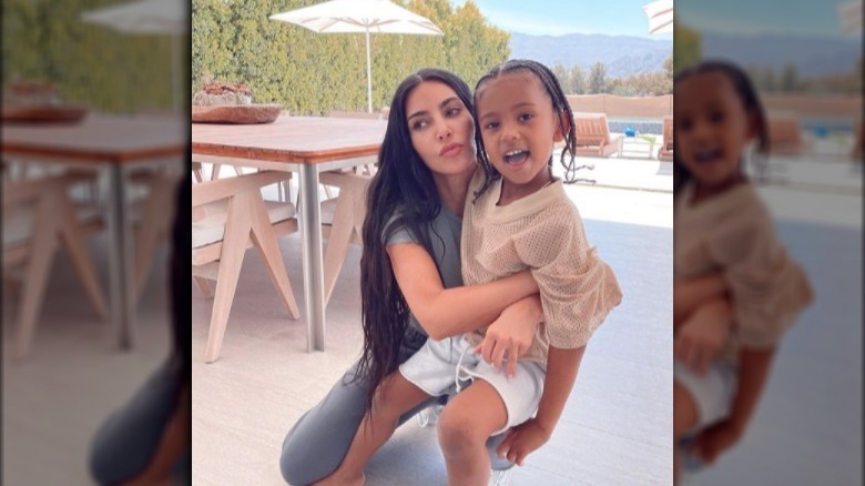 Kim Kardashian and Saint West posing for a picture