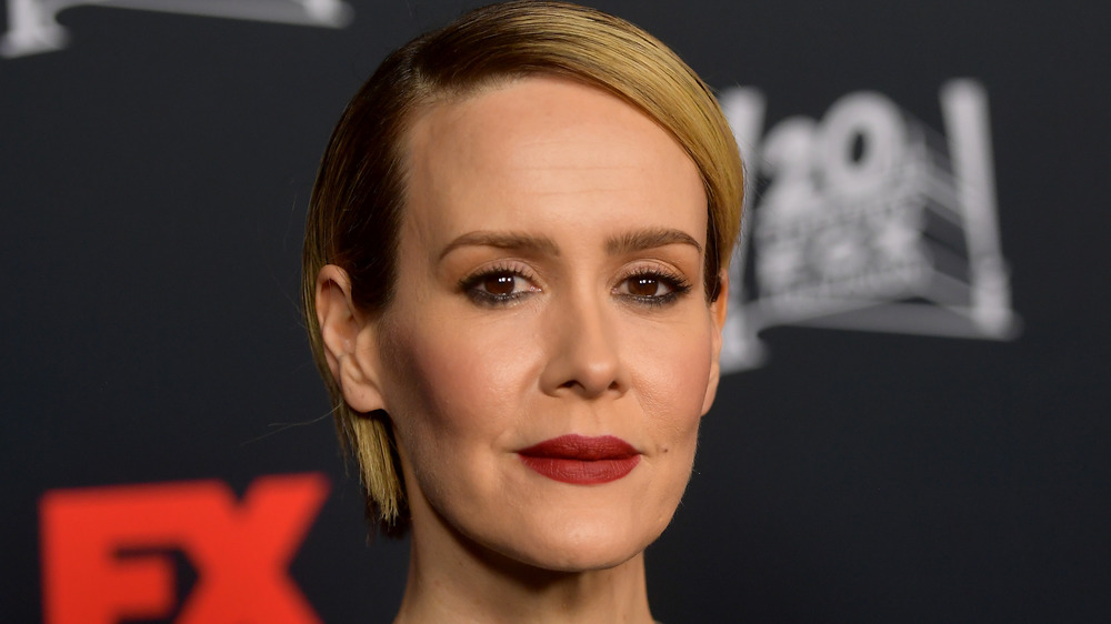 Sarah Paulson with blond hair, in a black shirt, not smiling at FX premiere 