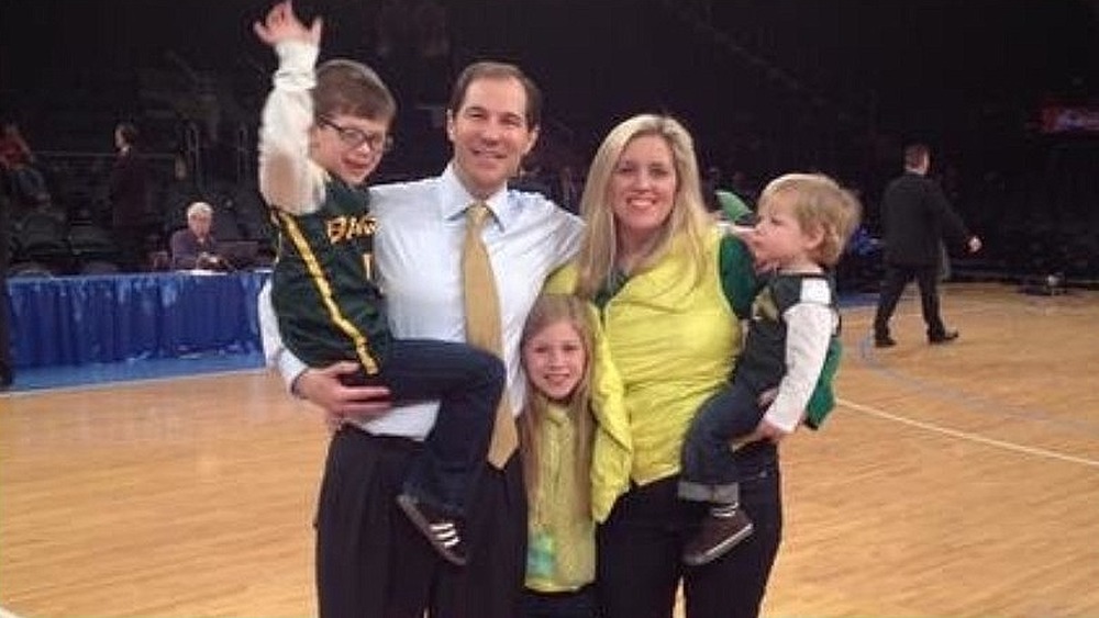 Scott and Kelly Drew posing with their kids on the court 