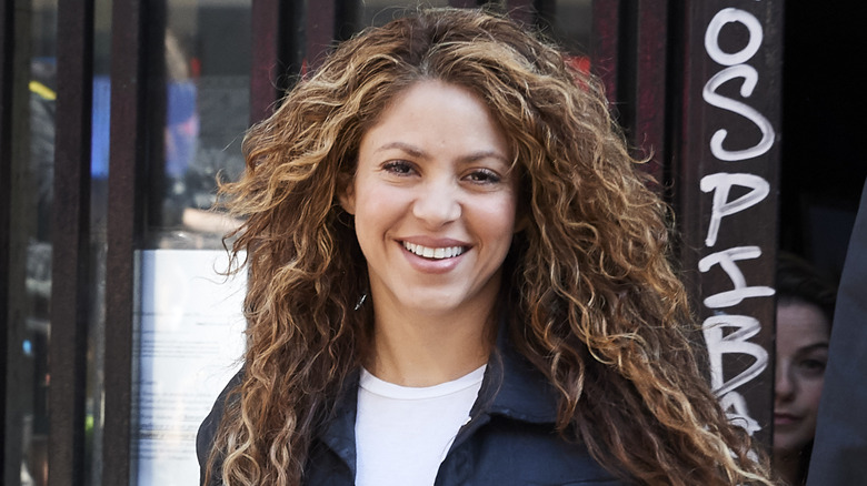 Shakira smiling with curly hair