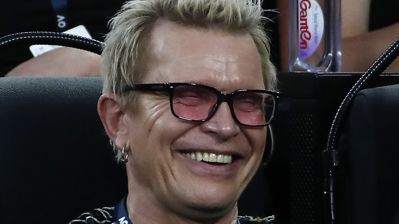 Billy Idol smiling in sunglasses