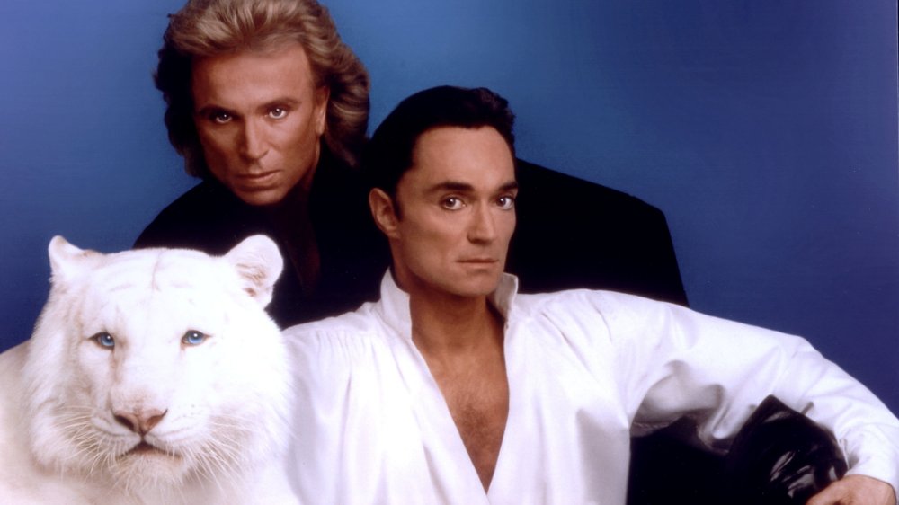 World-renowned illusionists and conservationists Siegfried & Roy pose with their white tiger in this undated photo.