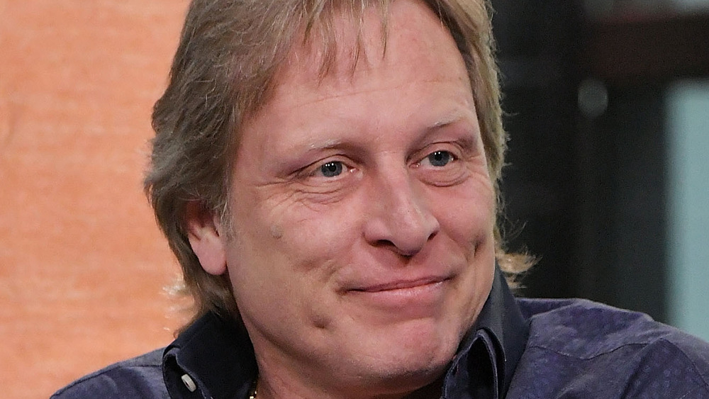 Sig Hansen gives an amused expression while speaking at an event