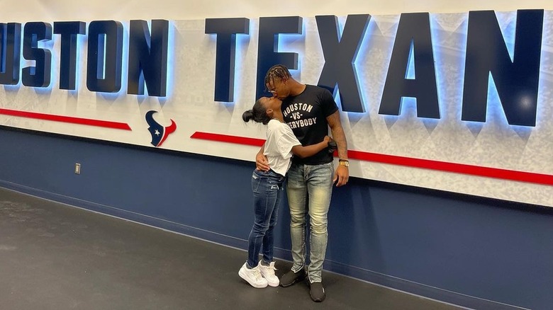 Simone Biles and Jonathan Owens kissing at training camp