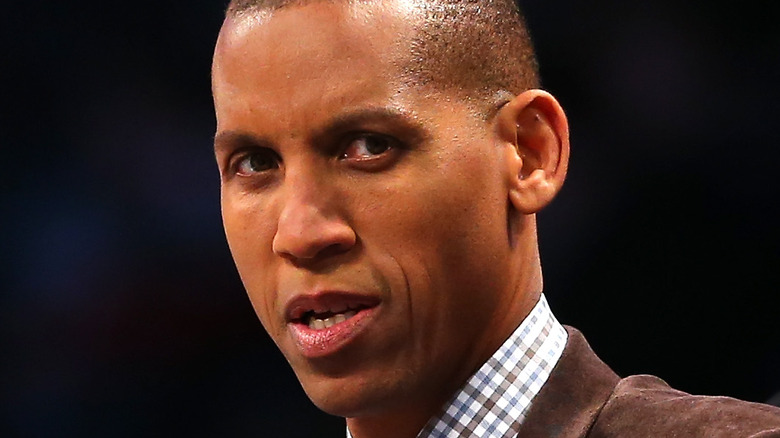 Reggie Miller wearing a brown blazer and checkered shirt