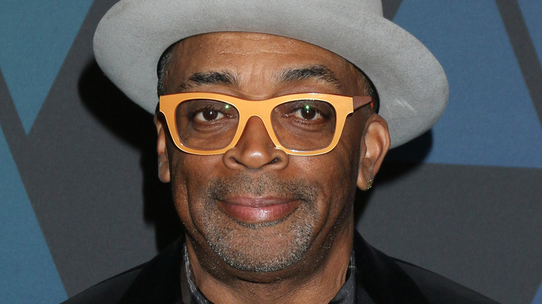 Spike Lee wearing a gray fedora 