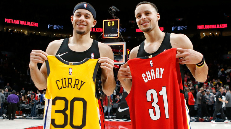 Curry brothers hold up jerseys