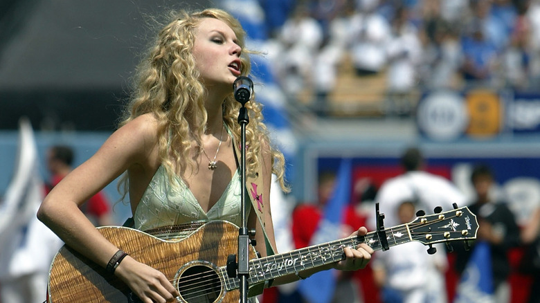 Taylor Swift singing and playing guitar