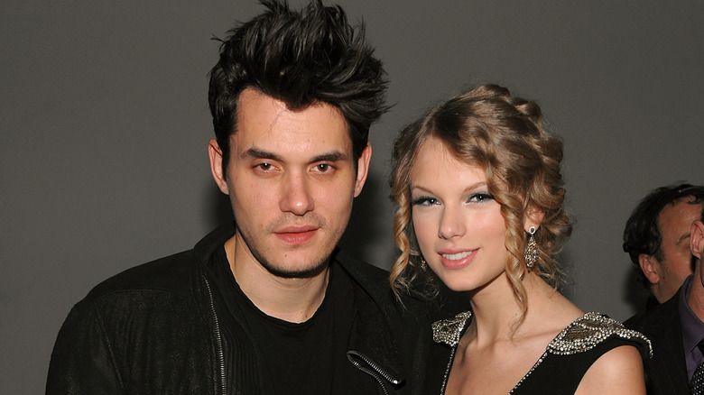 John Mayer and Taylor Swift posing on red carpet