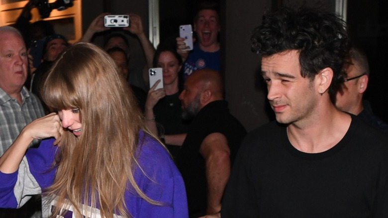 Taylor Swift walking next to Matty Healy