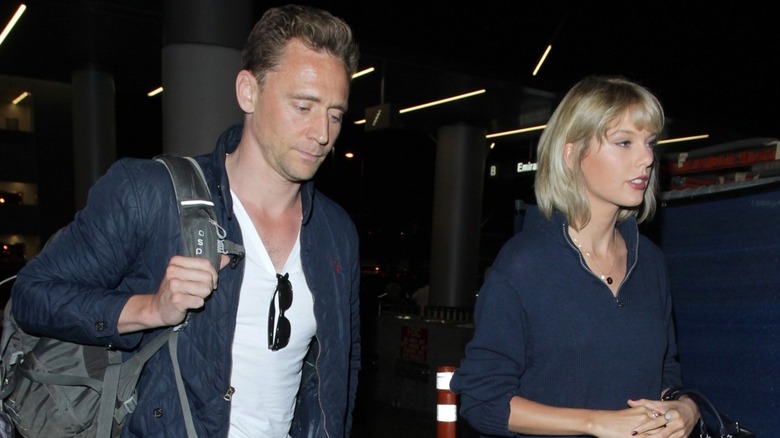 Taylor Swift and Tom Hiddleston walking together