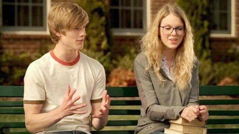 Lucas Till and Taylor Swift sitting on bench