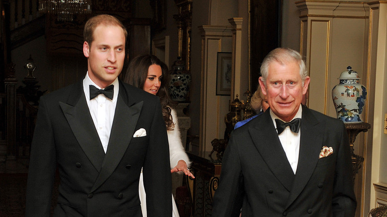 Prince William and Prince Charles in tuxedos.