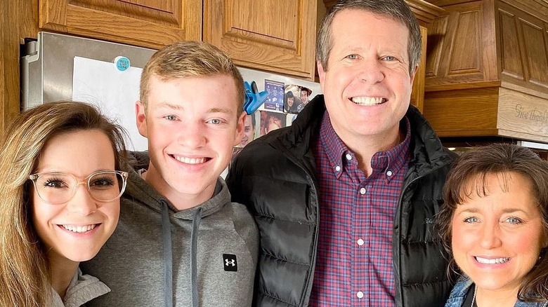 Jim Bob, Michelle Duggar smiling with son and wife