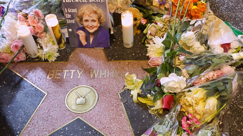 Betty White's star on the Walk of Fame surrounded by flowers
