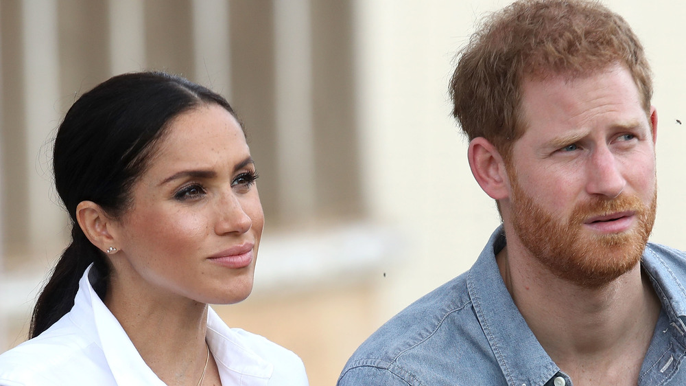 Meghan Markle and Prince Harry reacts to something while on an engagement in South Africa