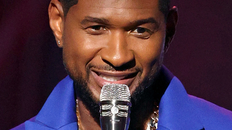 Usher speaks on stage