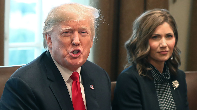 Donald Trump speaking beside Kristi Noem