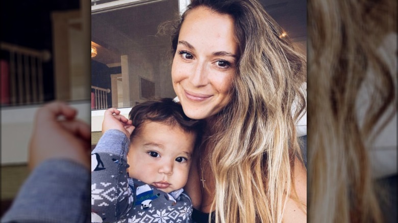 Alexa PenaVega posing with her son Kingston