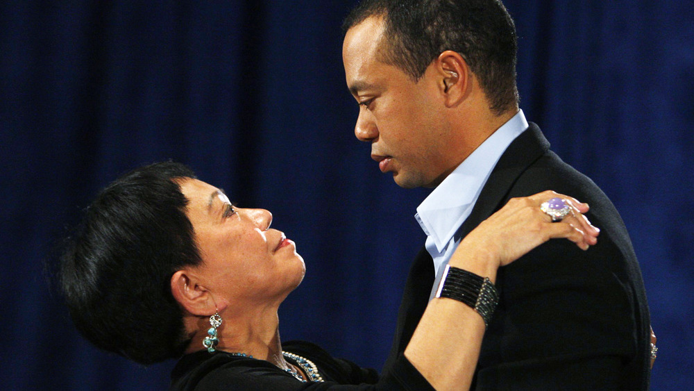 Kultida Woods hugs son Tiger Wood at a press conference