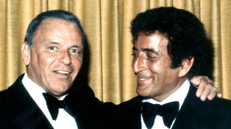 Frank Sinatra with arm around Tony Bennett