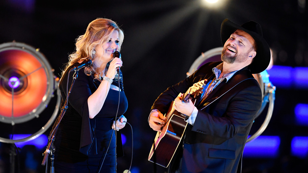 Trisha Yearwood and Garth Brooks performing together at the Grand Ole Opry 2014
