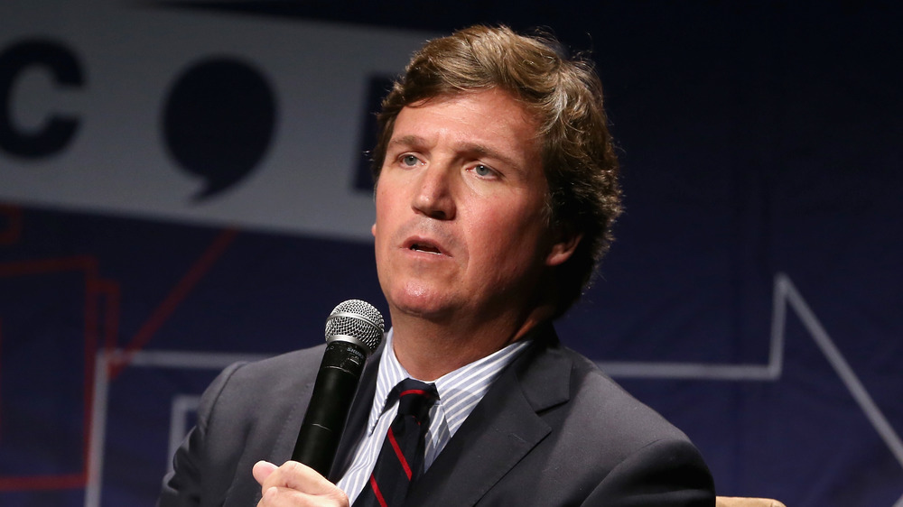 Tucker Carlson on stage speaking