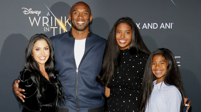 Kobe and Vanessa Bryant posing with Natalia and Gianna