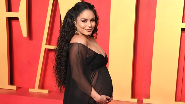 Vanessa Hudgens holding baby bump