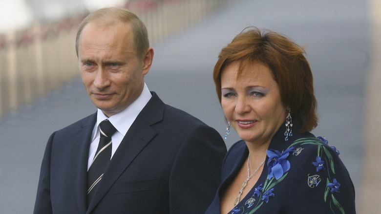 Vladimir Putin and [now ex-wife] Lyudmila both standing outside