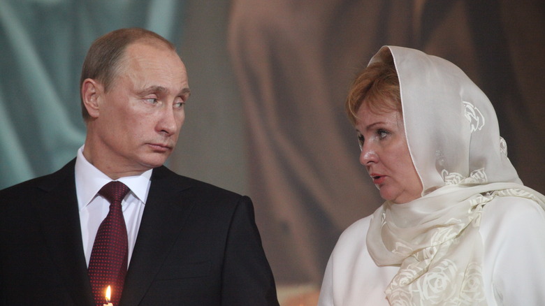 Vladimir Putin and Lyudmila speaking to one another