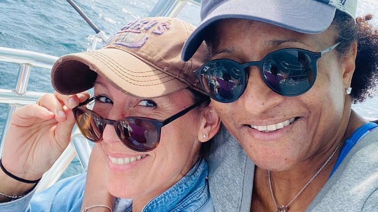 Alex Sykes and Wanda Sykes smiling together on the water