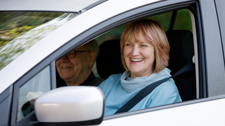 Susie Buffett laughing in car