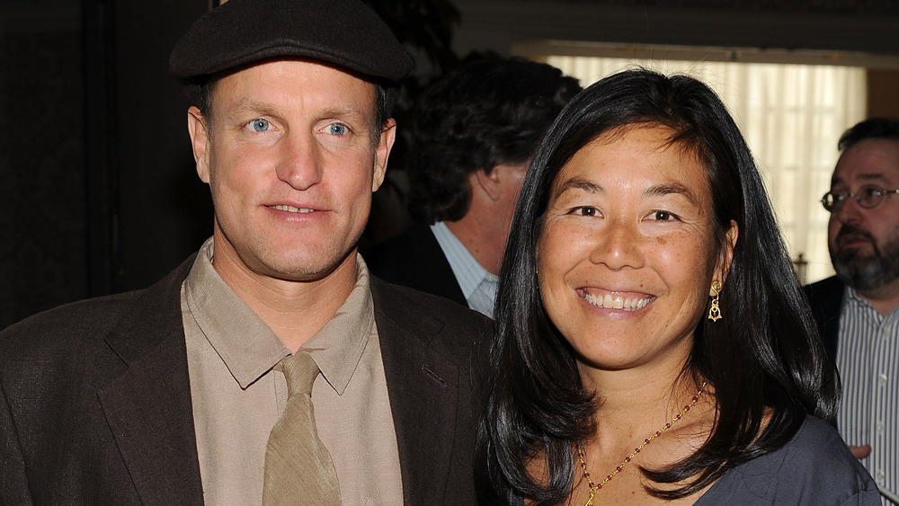 Woody Harrelson and Laura Louie both smiling