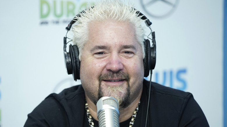 Guy Fieri speaking and wearing headphones