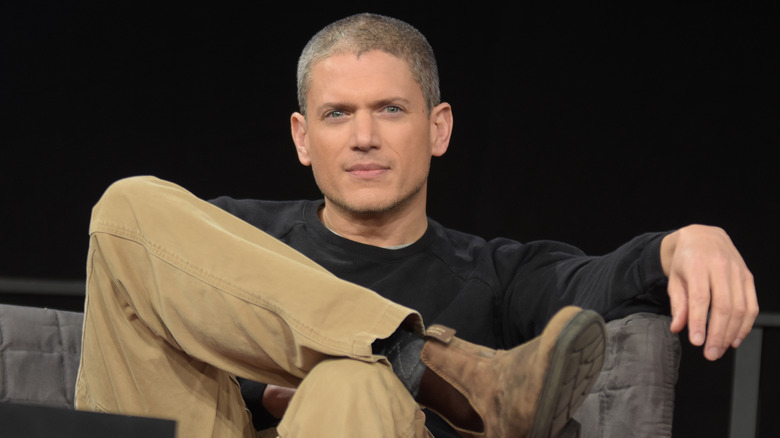 Wentworth Miller sitting in a chair with leg crossed