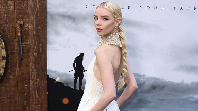 Anya Taylor-Joy posing in all white