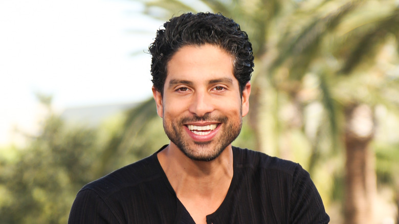 Adam Rodriguez smiling outdoors