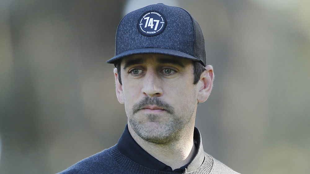 Aaron Rodgers looking somber at the AT&T Pebble Beach Pro-Am