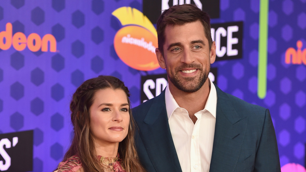 Danica Patrick and Aaron Rodgers smiling at the Nickelodeon Kids' Choice Sports event