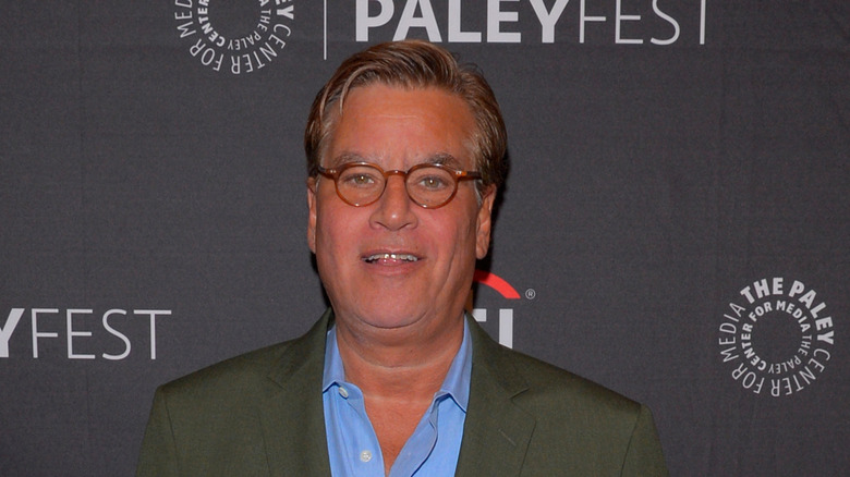 Aaron Sorkin smiling in red glasses at Paley Fest