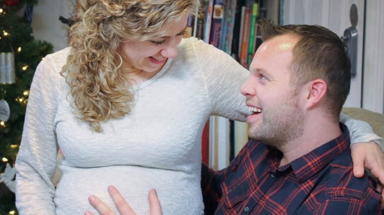 John David and pregnant Abbie in their living room