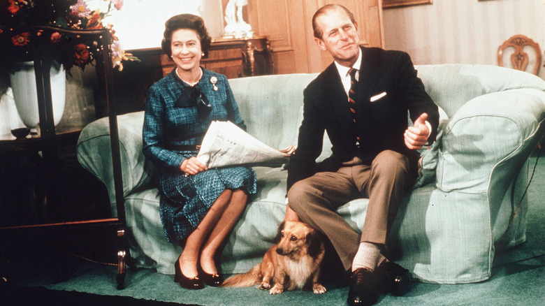 Queen Elizabeth and Prince Philip sitting on couch