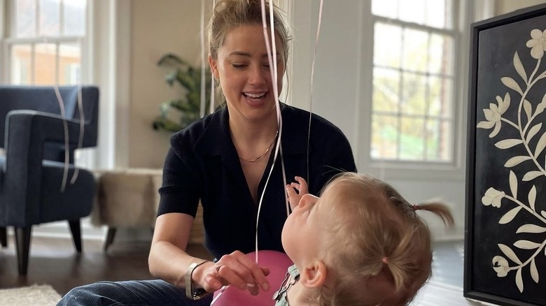 Amber Heard playing with her baby daughter