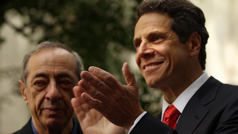 Mario Cuomo looking to the side as Andrew Cuomo claps
