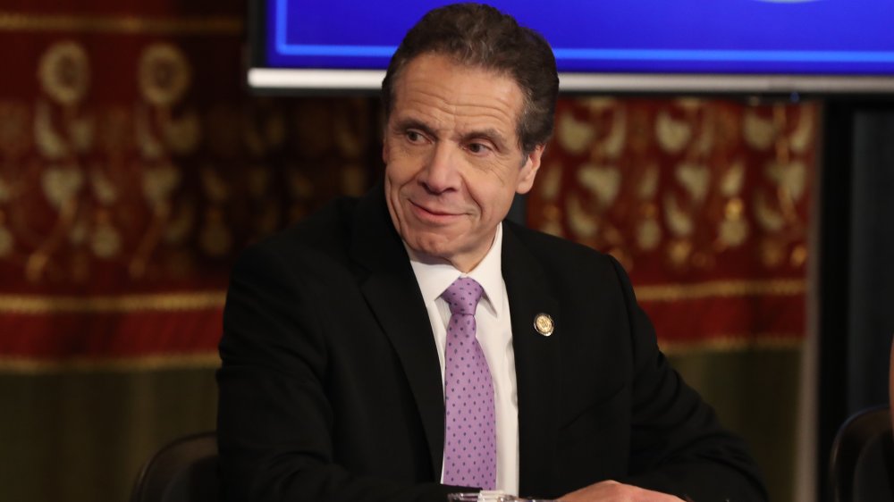 Andrew Cuomo looking to the side and smiling