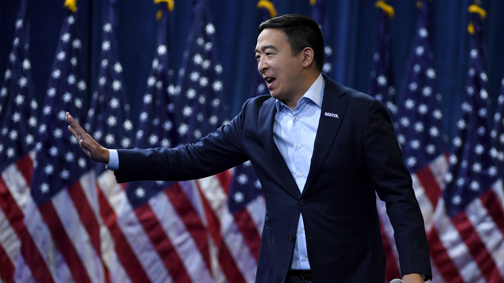 Andrew Yang in front of American flags