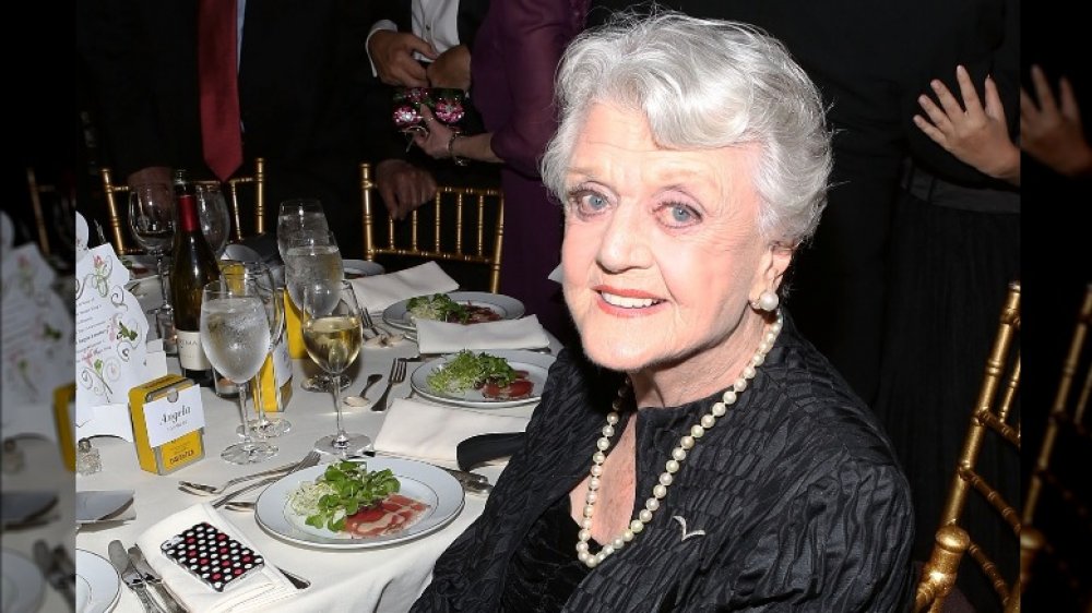 Angela Lansbury sitting at table