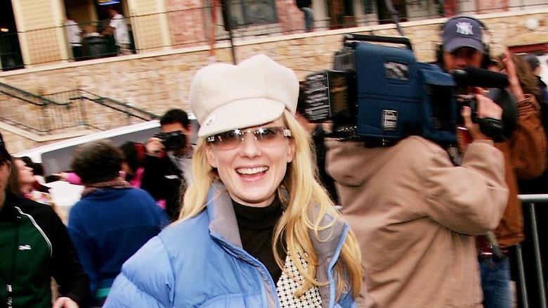 Anne Heche smiling with coat